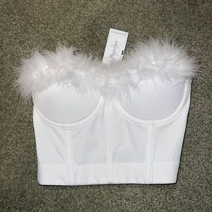 This cute white top is super comfortable and adorable on. Never been worn